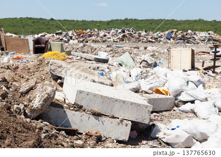 Municipal garbage dump at landfill. Environmental pollution. 137765630