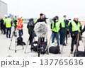 Microphone in focus against blurred camera operators and journalists at news conference 137765636