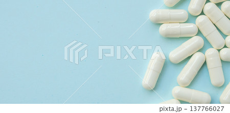 White medicine pills capsule on blue background White medicine pills capsule on blue background 137766027
