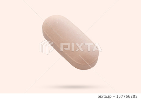 Pink medicine pill tablet float on beige background 137766285