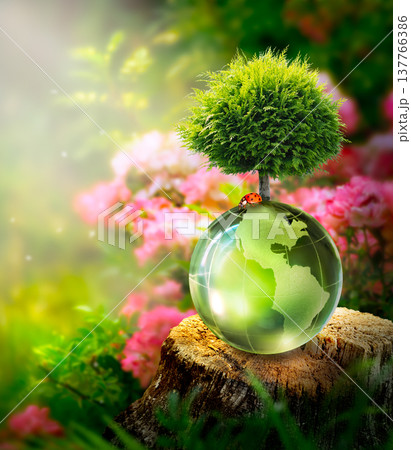 Earth Day or World Environment Day concept. Save Planet and Green Nature. Globe and Tree in forest. 137766386