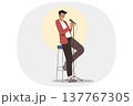 Stand-up show from man comedian standing on stage with microphone in hand, near chair and spotlight 137767305