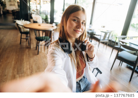 Making a selfie. Young woman is in the cafe at daytime 137767685