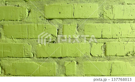 Close-up of a textured light green painted brick wall with natural cracks and industrial charm 137768013