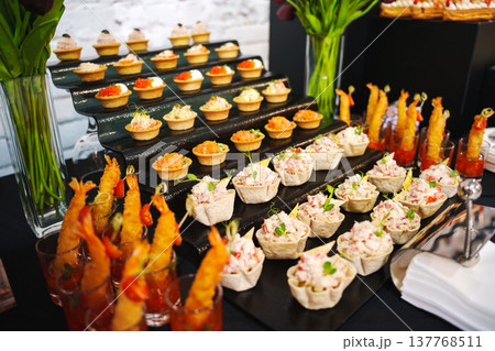 Food display at a catering event with various dishes served Food display at a catering event with various dishes served 137768511