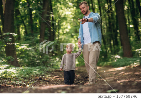 Dad with his little boy son is in the forest Dad with his little boy son is in the forest 137769246