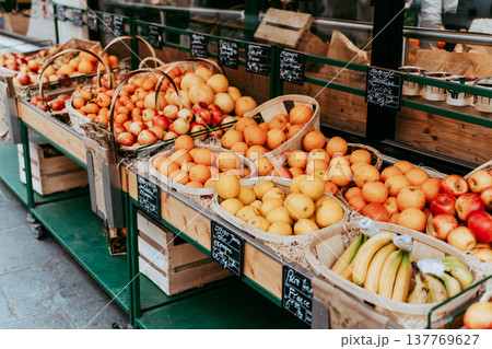 Fresh fruits displayed at a colorful street market stall Fresh fruits displayed at a colorful street market stall 137769627