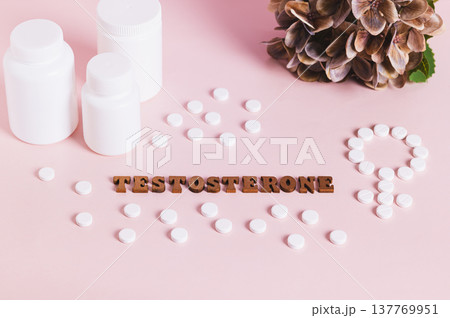 Testosterone, medication, bottles for women therapy on pink background 137769951