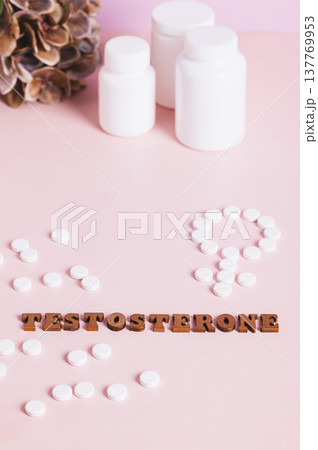 Testosterone, medication, bottles for women therapy on pink background vertical view 137769953
