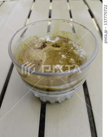 Glass of espresso shot over cold fresh milk 137770722