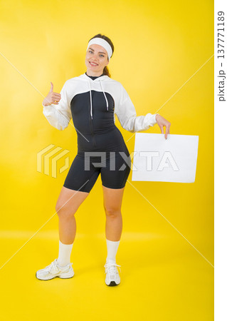 Young woman holding blank sign giving thumbs up Young woman holding blank sign giving thumbs up 137771189