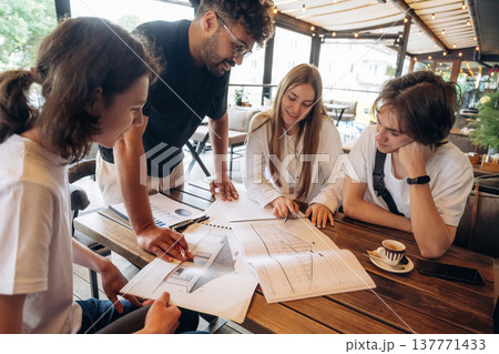 Cool start up, working on the project. Group of young friends are in the cafe restaurant 137771433