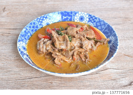 spicy boiled slice beef meat with lemon leaf and eggplant in coconut milk red curry soup on plate spicy boiled slice beef meat with lemon leaf and eggplant in coconut milk red curry soup on plate 137771656