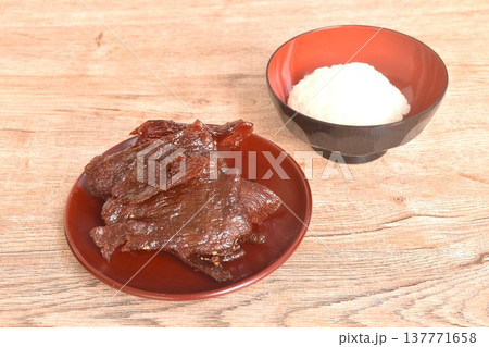 salty and sweet dry fried slice beef meat fermenting in sesame oil and pepper on plate eat couple sticky rice 137771658