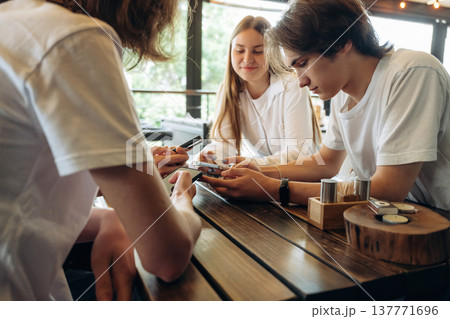 Addicted to smartphones. Group of young friends are in the cafe restaurant Addicted to smartphones. Group of young friends are in the cafe restaurant 137771696