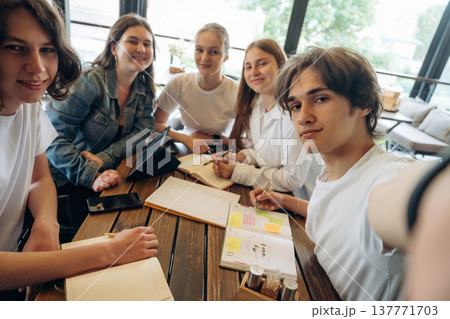 Making selfie. Group of young friends are in the cafe restaurant Making selfie. Group of young friends are in the cafe restaurant 137771703