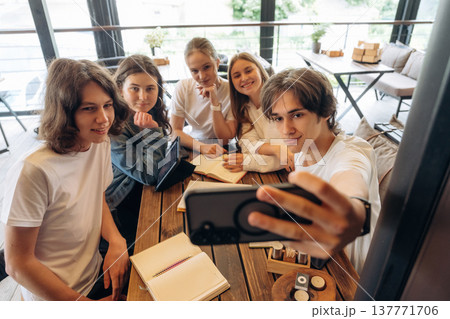 Making selfie. Group of young friends are in the cafe restaurant Making selfie. Group of young friends are in the cafe restaurant 137771706