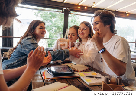 Cheerful facial expression, having fun. Group of young friends are in the cafe restaurant 137771718