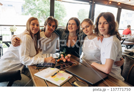Papers, document, laptop, education concept. Group of young friends are in the cafe restaurant Papers, document, laptop, education concept. Group of young friends are in the cafe restaurant 137771750