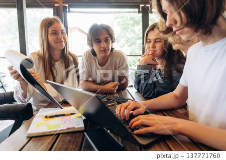Papers, document, laptop, education concept. Group of young friends are in the cafe restaurant 137771760