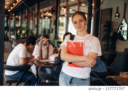 Front view, standing and posing. Group of young friends are in the cafe restaurant 137771767