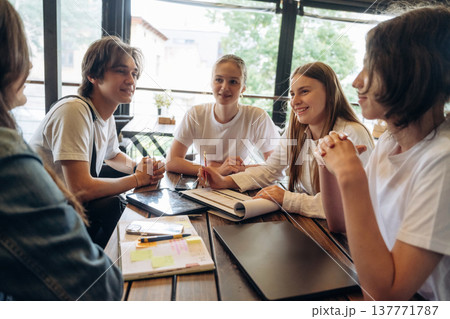 Job with documents in progress, start up. Group of young friends are in the cafe restaurant 137771787