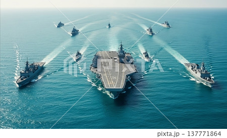 Aircraft carrier strike group formation with escort warships in blue ocean waters during naval military exercise demonstration Aircraft carrier strike group formation with escort warships in blue ocean waters during naval military exercise demonstration 137771864