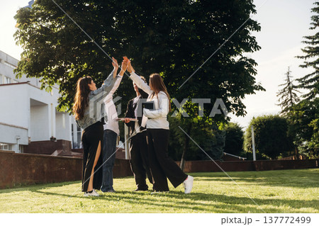 High five hands gesture, success. Group of students are near university together 137772499