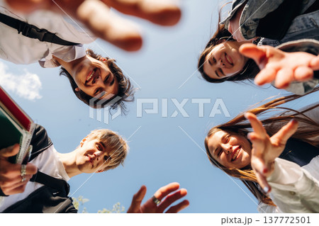 View from below of young friends against the sky View from below of young friends against the sky 137772501