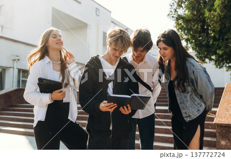 Against the stairs. Group of students are near university together Against the stairs. Group of students are near university together 137772724