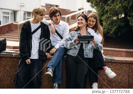 Feeling good, smiling. Group of students are near university together Feeling good, smiling. Group of students are near university together 137772788