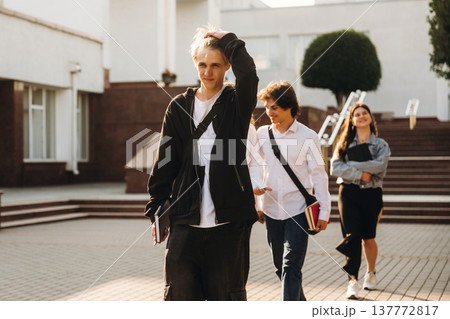 Modern look, walking. Group of students are near university together Modern look, walking. Group of students are near university together 137772817