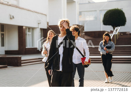 Modern look, walking. Group of students are near university together 137772818