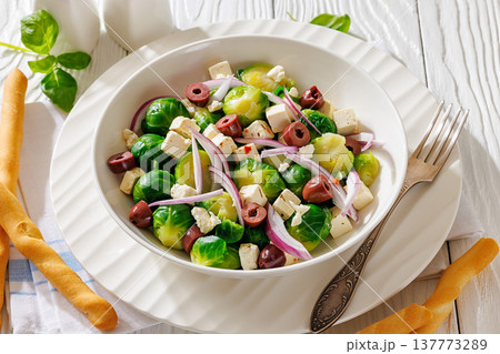brussels sprouts salad with feta, olives in bowl brussels sprouts salad with feta, olives in bowl 137773289