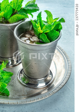 Mint Julep in the Kentucky Derby classic silver glass, with fresh mint leaves 137773410