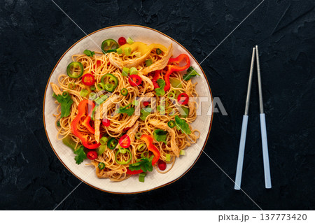 Chow Mein noodles with chicken and vegetables, overhead flat lay shot Chow Mein noodles with chicken and vegetables, overhead flat lay shot 137773420
