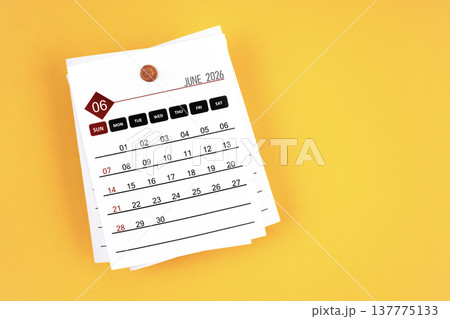 June 2026 calendar page with wooden push pin on yellow, position with copy space. June 2026 calendar page with wooden push pin on yellow, position with copy space. 137775133
