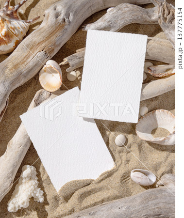 Wedding invitation card mockup set on sand with seashells and driftwood, coastal event design 137775154