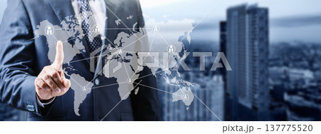 A businessman in a suit interacts with a digital world map overlay, illustrating global connectivity, international business networking, and communication technology against a city background A businessman in a suit interacts with a digital world map overlay, illustrating global connectivity, international business networking, and communication technology against a city background 137775520