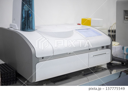 Professional automated biochemical analyzer in a modern clinical laboratory setting. High-tech medical equipment for precise diagnostic testing and blood analysis 137775549