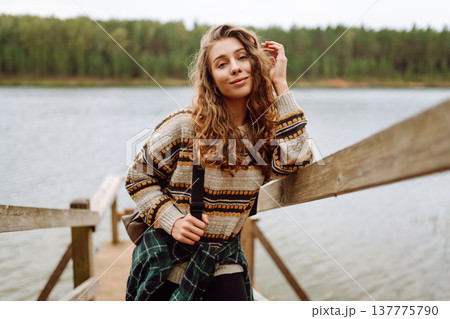 Attractive young woman enjoying fresh air on the lake. Travel, Hiking, nature Attractive young woman enjoying fresh air on the lake. Travel, Hiking, nature 137775790