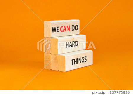 Support, help we can do hard things symbol. Concept words We can do hard things on beautiful wooden blocks. Beautiful orange background. Business we can do hard things concept. Copy space. Support, help we can do hard things symbol. Concept words We can do hard things on beautiful wooden blocks. Beautiful orange background. Business we can do hard things concept. Copy space. 137775939