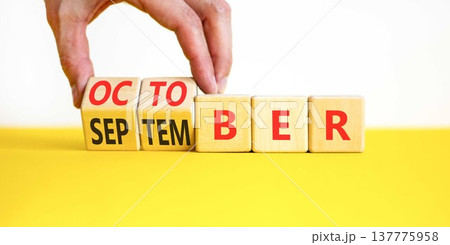 Symbol for the change from September to October. Concept words October to November on beautiful wooden blocks. Beautiful white background. Businessman's hand. Happy October concept. Copy space. 137775958