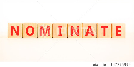 Nominate word symbol. Concept word Nominate on beautiful wooden blocks. Beautiful white background. Business support help nominate word concept. Copy space. Nominate word symbol. Concept word Nominate on beautiful wooden blocks. Beautiful white background. Business support help nominate word concept. Copy space. 137775999