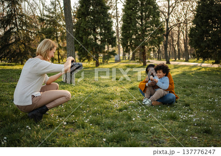 Mother and child posing for outdoor professional photography session Mother and child posing for outdoor professional photography session 137776247