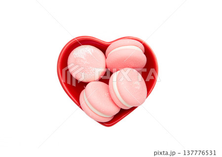 Pink macaroons in heart shaped bowl isolated on white background 137776531