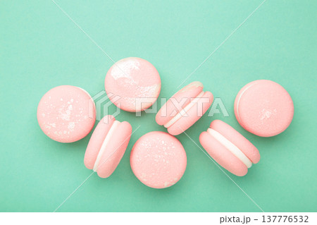 Pink macaroons on mint background. Macro photo Pink macaroons on mint background. Macro photo 137776532