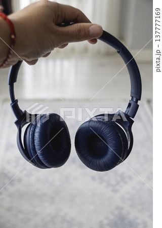 Close up of blue wireless headphones on the head 137777169