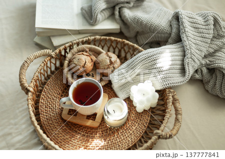 Home coziness composition with a cup of tea. Autumn home comfort. Home coziness composition with a cup of tea. Autumn home comfort. 137777841