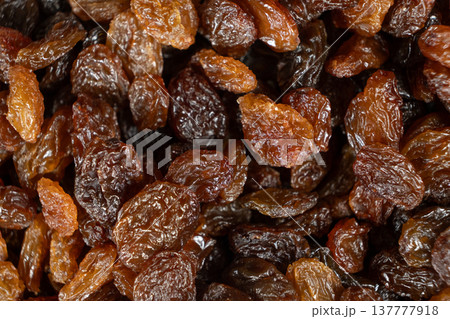Macro top view of dried grapes, sweet organic raisins. 137777918